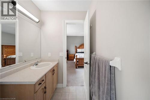 Light-toned wood-finish vanity with an integrated sink and mirror - 57 Grindstone Way, Waterdown, ON - Indoor Photo Showing Bathroom