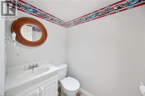 Built-in vanity with a white countertop and undermount sink, chrome faucet, and integrated storage - 57 Grindstone Way, Waterdown, ON - Indoor Photo Showing Bathroom