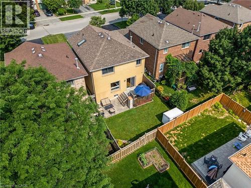 Rear exterior showcasing a deck with a privacy wall, a manicured lawn, and a fenced perimeter - 57 Grindstone Way, Waterdown, ON - Outdoor