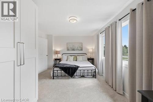 Recessed lighting, light gray carpeting, multiple windows, white paneled doors, and a ceiling-mounted light fixture - 15 Green Valley Drive Unit# 41, Kitchener, ON - Indoor Photo Showing Bedroom