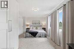 Recessed lighting, light gray carpeting, multiple windows, white paneled doors, and a ceiling-mounted light fixture - 
