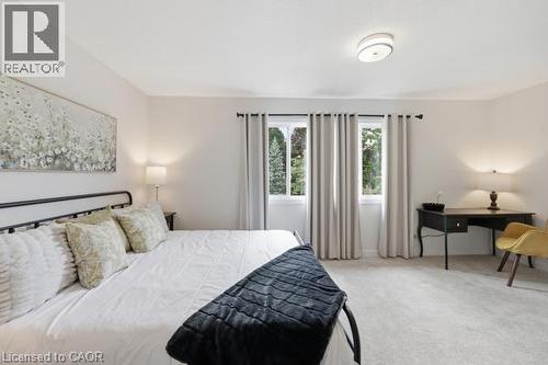 Ceiling-mounted light fixture, dual windows, light-colored carpeting, and light wall paint - 15 Green Valley Drive Unit# 41, Kitchener, ON - Indoor Photo Showing Bedroom