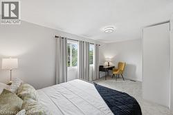 Textured ceiling with a flush-mount light fixture, light gray walls, and light gray carpeting - 