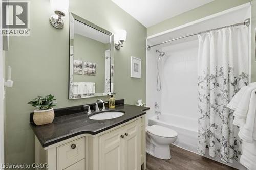 Bathroom featuring a vanity with dark countertop, undermount sink, and chrome fixtures - 15 Green Valley Drive Unit# 41, Kitchener, ON - Indoor Photo Showing Bathroom