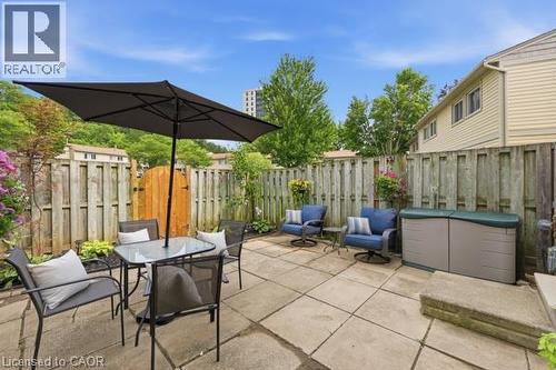 Paved patio area, privacy fencing, and exterior siding - 15 Green Valley Drive Unit# 41, Kitchener, ON - Outdoor With Deck Patio Veranda With Exterior