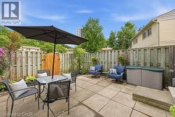 Paved patio area, privacy fencing, and exterior siding - 