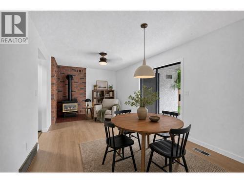 Dining room/Family room *virtually staged with added light fixture* - 1494/1496 Elm Street, Kelowna, BC - Indoor Photo Showing Dining Room With Fireplace