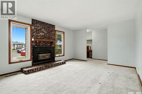 65 Mccaul Crescent, Regina, SK - Indoor Photo Showing Other Room With Fireplace