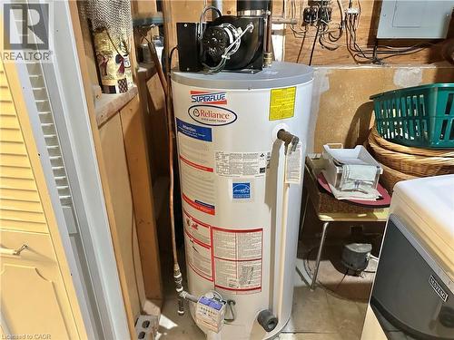In the corner of the laundry room is the rented hot water tank - 44 Douglas Avenue, Simcoe, ON - Indoor Photo Showing Basement