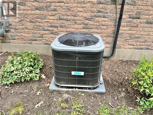 Brick exterior with an outdoor air conditioning unit - 44 Douglas Avenue, Simcoe, ON - Outdoor