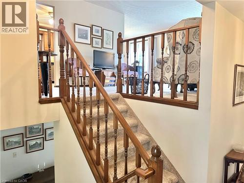 Wood-finish balusters and handrail with carpeted stairs - Going up to the Living Room - 44 Douglas Avenue, Simcoe, ON - Indoor Photo Showing Other Room