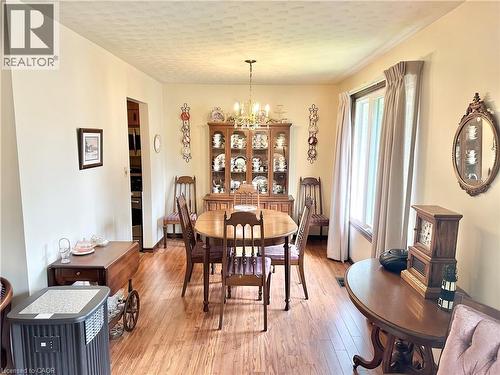Dining Room - with laminate  flooring with a ceiling-mounted light fixture, recessed window, and built-in display cabinetry - 44 Douglas Avenue, Simcoe, ON - Indoor Photo Showing Dining Room