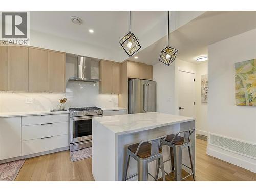 Quartz counters • waterfall island • KitchenAid appliances - 747 Patterson Avenue Unit# 2, Kelowna, BC - Indoor Photo Showing Kitchen With Upgraded Kitchen