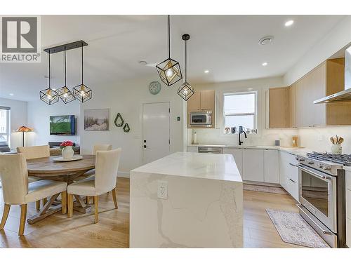 “Quartz waterfall island anchors the contemporary kitchen - 747 Patterson Avenue Unit# 2, Kelowna, BC - Indoor