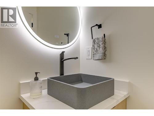 Stone vessel sink • backlit mirror - 747 Patterson Avenue Unit# 2, Kelowna, BC - Indoor Photo Showing Other Room