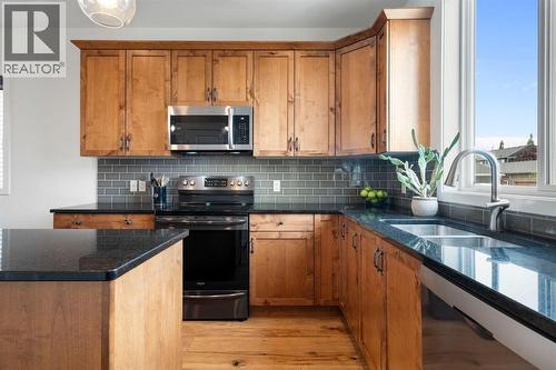 12 Fireside Burrow, Cochrane, AB - Indoor Photo Showing Kitchen With Double Sink