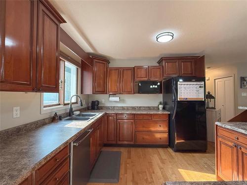 Kitchen with Island - 115 Mcvicar Crescent, Brandon, MB - Indoor Photo Showing Kitchen With Double Sink