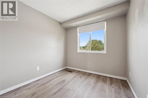 Wood-finish flooring, neutral wall tones, and white trim - 750 Erinbrook Drive Unit# 2, Kitchener, ON - Indoor Photo Showing Other Room