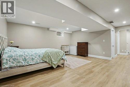 Bright, spacious rec-room with light-toned wood-finish flooring, recessed lighting, and neutral wall paint - 568 Robert Ferrie Drive, Kitchener, ON - Indoor Photo Showing Basement