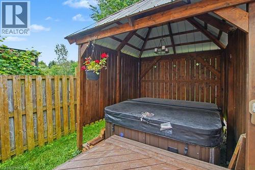 Gazebo with hot-tub, a metal roof, wood-finish walls, and a built-in chandelier - 568 Robert Ferrie Drive, Kitchener, ON - Outdoor With Exterior