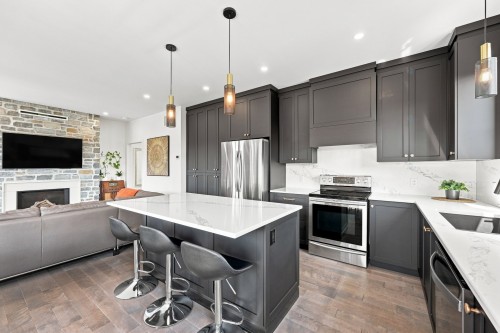 Kitchen - 48 Boul. Des Mésanges, Saint-Charles-Borromée, QC - Indoor Photo Showing Kitchen With Fireplace With Upgraded Kitchen