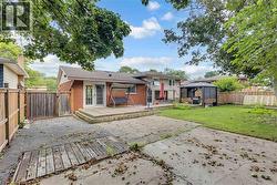 Brick exterior, wood deck, double French doors, concrete patio, fenced backyard - 