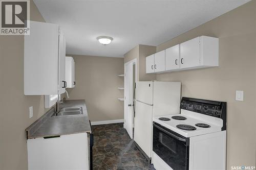 34 Armstrong Bay, Regina, SK - Indoor Photo Showing Kitchen With Double Sink