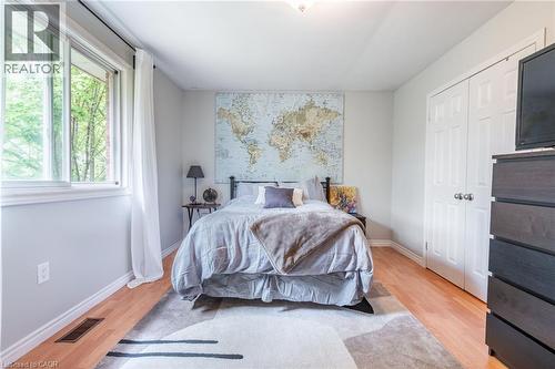 Recessed ceiling light, wood-finish flooring, white trim, sliding window, and a built-in closet with panel doors - 152 Concession 7 Road E, Millgrove, ON - Indoor Photo Showing Bedroom