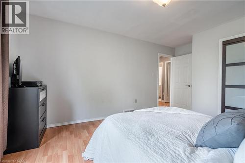 Wood-finish flooring, light grey wall paint, and a semi-flush ceiling light fixture - 152 Concession 7 Road E, Millgrove, ON - Indoor Photo Showing Bedroom