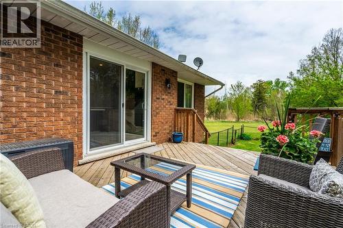 Expansive wood deck with a sliding glass door entry to the brick-clad exterior - 152 Concession 7 Road E, Millgrove, ON - Outdoor With Deck Patio Veranda With Exterior