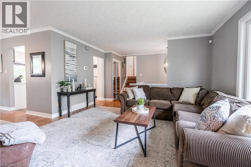 Spacious living area featuring light gray walls, white crown molding, and wood-finish flooring - 152 Concession 7 Road E, Millgrove, ON - Indoor Photo Showing Living Room