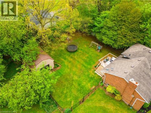 Expansive backyard featuring a manicured lawn, an elevated wood-tone deck, a detached shed, brick exterior, and mature trees - 152 Concession 7 Road E, Millgrove, ON - Outdoor