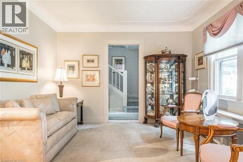 Recessed window with valance, light-toned carpeting, and a built-in display cabinet - 107 Bond Street S, Hamilton, ON - Indoor Photo Showing Living Room