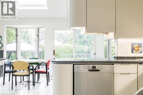 Kitchen featuring a skylight, bay window, light-toned cabinetry, and a built-in stainless steel dishwasher - 107 Bond Street S, Hamilton, ON - Indoor Photo Showing Kitchen