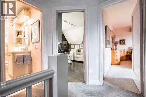 Neutral color palette, carpeted hallway, wood-finish flooring, recessed lighting, built-in vanity - 107 Bond Street S, Hamilton, ON - Indoor Photo Showing Other Room