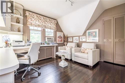Dark wood-finish flooring with built-in desk and cabinetry - 107 Bond Street S, Hamilton, ON - Indoor Photo Showing Office