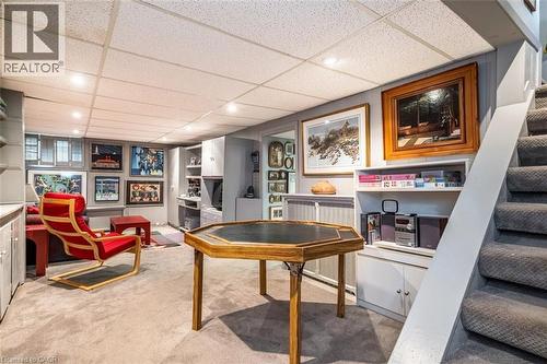 Recessed lighting, wood-finish wall paneling, built-in shelving, built-in cabinetry, and carpeted flooring - 107 Bond Street S, Hamilton, ON - Indoor