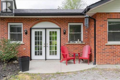 Brick exterior with a curved concrete patio - 111 Decou Road, Simcoe, ON - Outdoor With Exterior