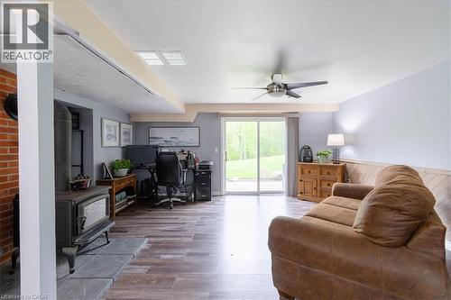 Main level family room with wood burning stove - 111 Decou Road, Simcoe, ON - Indoor Photo Showing Living Room