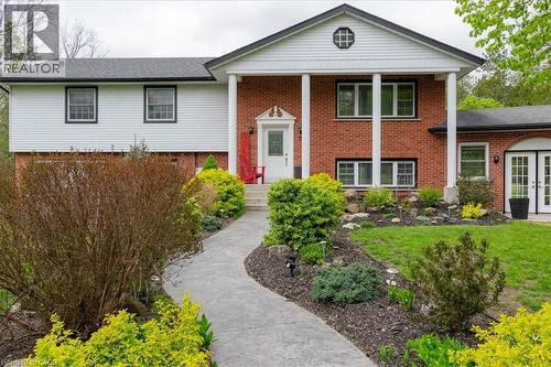 Traditional brick and siding exterior with a covered porch entry - 111 Decou Road, Simcoe, ON - Outdoor