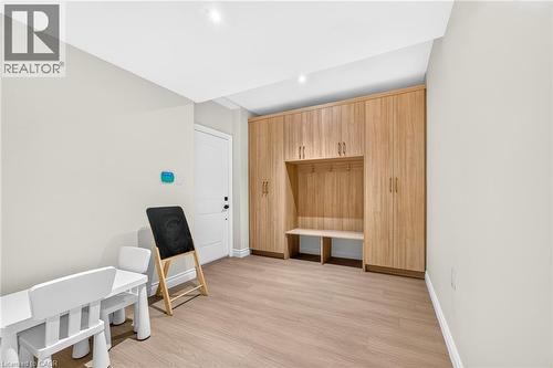 Wood-finish flooring, recessed lighting, built-in mudroom storage with bench, and solid core door - 67 Cielo Court, Hamilton, ON - Indoor