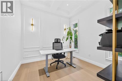 Wainscoting paneling, crown molding, coffered ceiling, wood-finish flooring, and two wall-mounted light fixtures - 67 Cielo Court, Hamilton, ON - Indoor Photo Showing Office