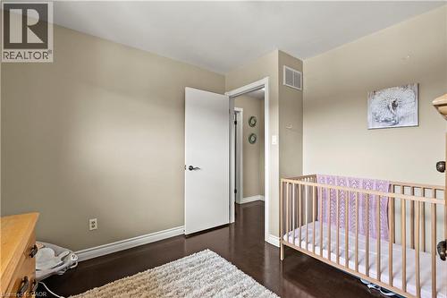 Wood-finish flooring, light neutral wall paint, and white trim throughout - 87 Monte Drive, Hamilton, ON - Indoor Photo Showing Bedroom