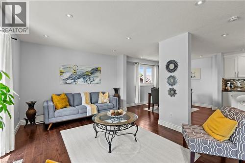 Recessed lighting, wood-finish flooring, white trim, and a window with white blinds - 87 Monte Drive, Hamilton, ON - Indoor Photo Showing Living Room