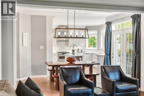 Recessed lighting, wood-finish flooring, white cabinetry, stainless steel appliances, and French doors - 536 Cusick Circle, Milton, ON - Indoor Photo Showing Living Room