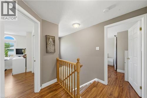 Upper-level hallway featuring wood-finish flooring, a wood banister, and neutral wall tones - 784 Butternut Avenue, Waterloo, ON - Indoor Photo Showing Other Room