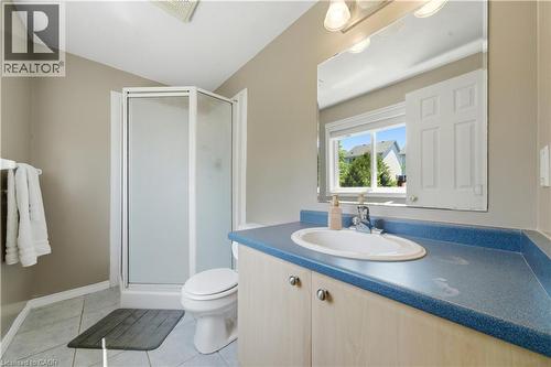 Bathroom with a corner shower enclosure, light neutral wall paint, and grey floor tiles - 784 Butternut Avenue, Waterloo, ON - Indoor Photo Showing Bathroom