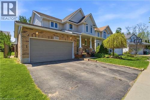 Brick and siding exterior featuring a two-car garage with a gray door - 784 Butternut Avenue, Waterloo, ON - Outdoor With Facade