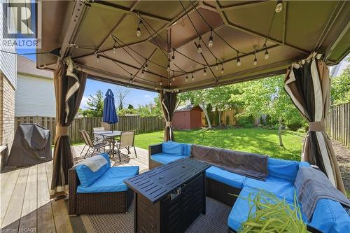 Spacious outdoor deck featuring a large gazebo with string lighting, privacy curtains, and a built-in outdoor kitchen area - 784 Butternut Avenue, Waterloo, ON - Outdoor With Deck Patio Veranda With Exterior