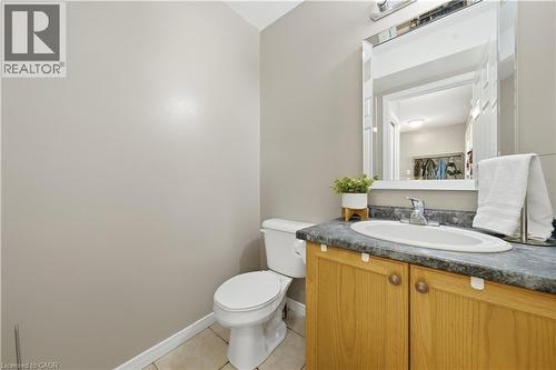 Powder room featuring a single vanity with a laminate countertop, an undermount sink, and a framed mirror - 784 Butternut Avenue, Waterloo, ON - Indoor Photo Showing Bathroom